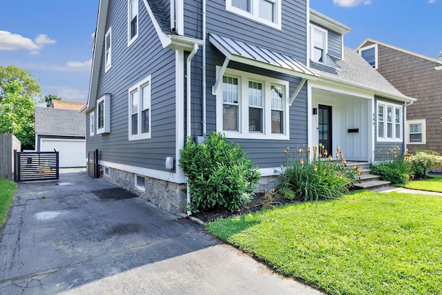 946 Wilcoxson Ave, Stratford, CT 06614 - view of front of property featuring an outdoor structure, a front lawn, and a garage