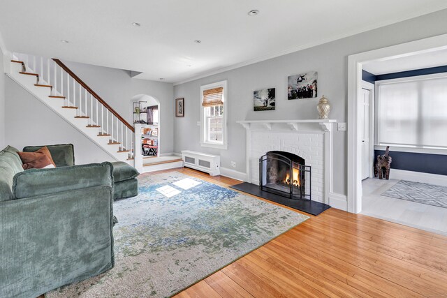 946 Wilcoxson Ave, Stratford, CT 06614 - living area with arched walkways, wood finished floors, and a brick fireplace