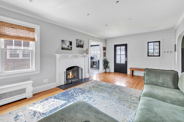 946 Wilcoxson Ave, Stratford, CT 06614 - living room with wood finished floors, a fireplace, ornamental molding, and arched walkways