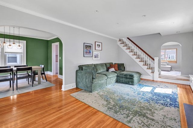 946 Wilcoxson Ave, Stratford, CT 06614 - living area with arched walkways, light wood-type flooring, stairs, and crown molding