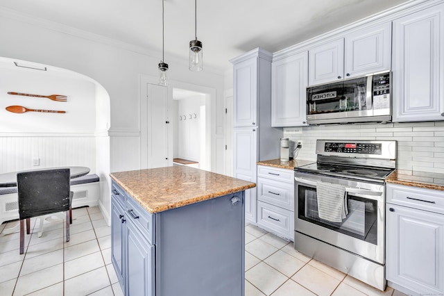 946 Wilcoxson Ave, Stratford, CT 06614 - kitchen with appliances with stainless steel finishes, light tile patterned floors, backsplash, a kitchen island, and crown molding
