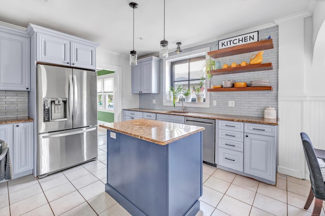 946 Wilcoxson Ave, Stratford, CT 06614 - kitchen featuring stainless steel appliances, light tile patterned floors, ornamental molding, tasteful backsplash, and a wainscoted wall