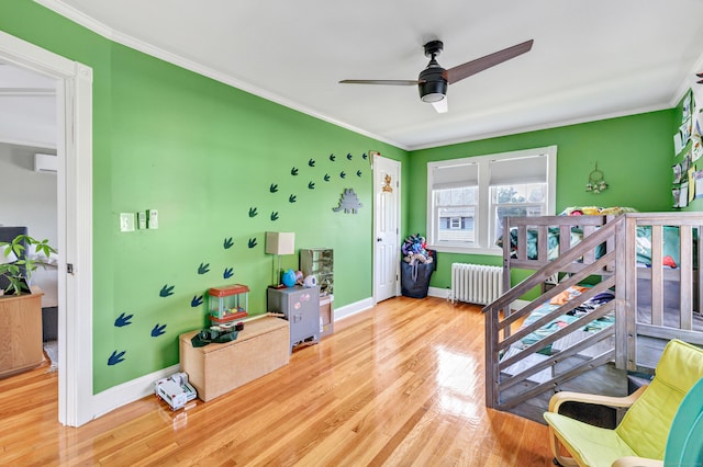 946 Wilcoxson Ave, Stratford, CT 06614 - bedroom with radiator, crown molding, wood finished floors, an AC wall unit, and ceiling fan