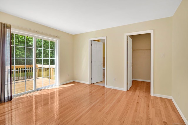 125 E Old Route 6, Hampton, CT 06247 - unfurnished bedroom featuring access to outside, light wood-style flooring, a walk in closet, and a closet