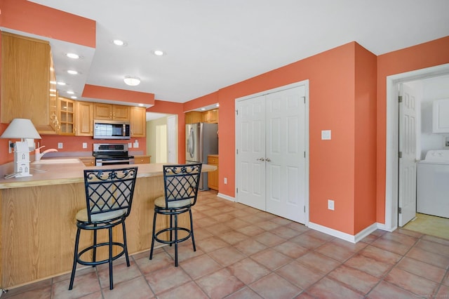 125 E Old Route 6, Hampton, CT 06247 - kitchen featuring appliances with stainless steel finishes, washer / dryer, a peninsula, glass insert cabinets, and light countertops