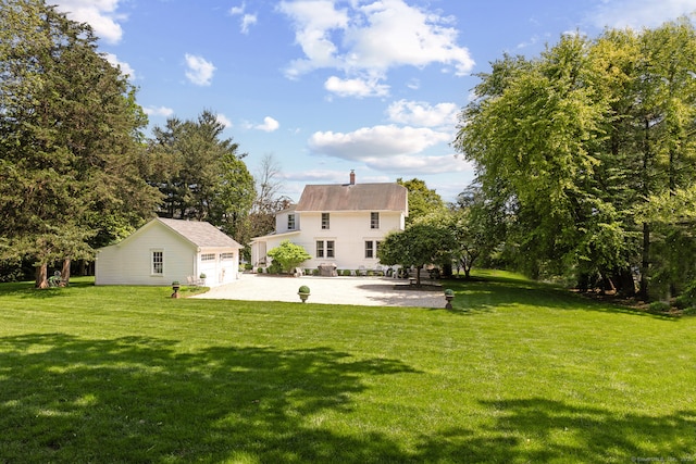 7 Morningside Ln, Westport, CT 06880 - view of green lawn featuring an outdoor structure, driveway, and a patio