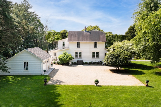 7 Morningside Ln, Westport, CT 06880 - rear view of property with a yard, an outdoor structure, driveway, and a chimney