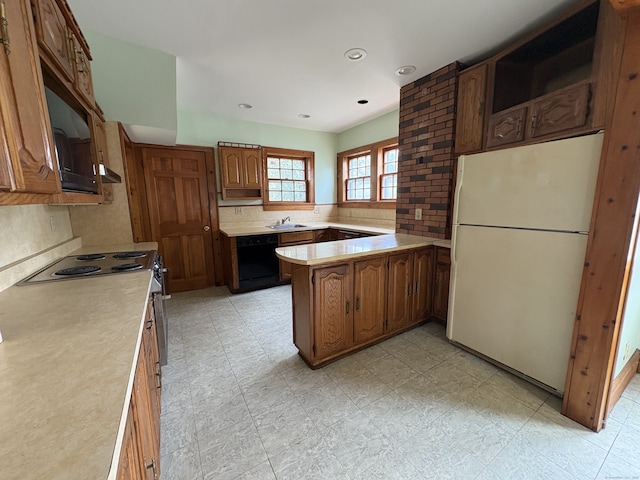 5 Lindsley Pl, Stratford, CT 06615 - kitchen with freestanding refrigerator, dishwasher, light countertops, backsplash, and a peninsula