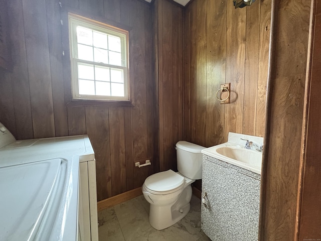 5 Lindsley Pl, Stratford, CT 06615 - bathroom featuring vanity, wooden walls, washer / clothes dryer, and marble look tiles