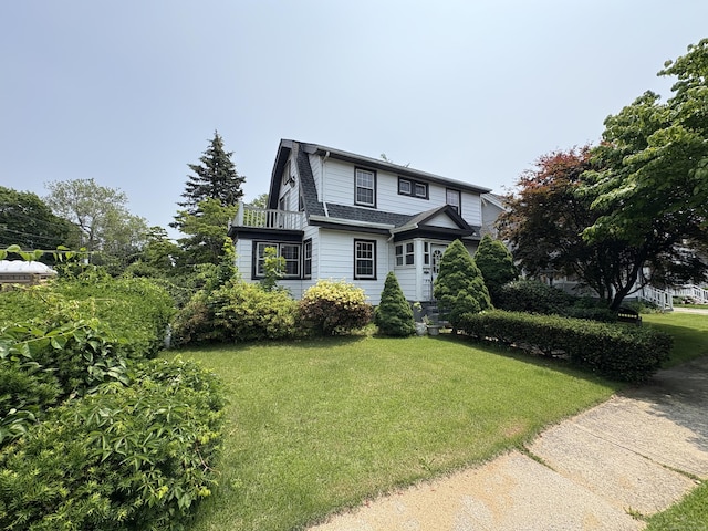 5 Lindsley Pl, Stratford, CT 06615 - view of front facade featuring a front lawn, a balcony, and a shingled roof