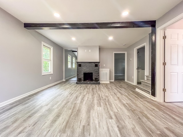45 Cedar Ave, Wolcott, CT 06716 - unfurnished living room featuring beamed ceiling, light wood-type flooring, stairway, a stone fireplace, and recessed lighting
