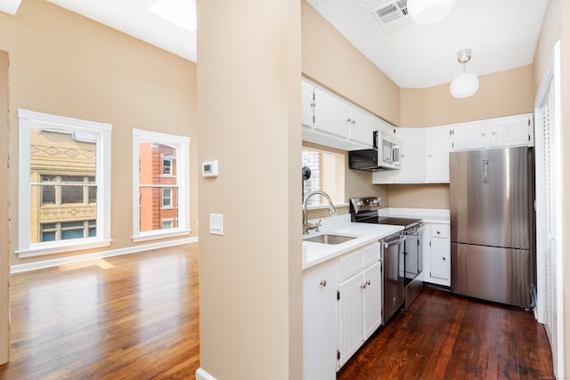 118 Washington St # U304, Norwalk, CT 06854 - kitchen with stainless steel appliances, dark wood-style floors, light countertops, and white cabinetry