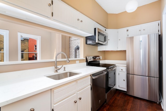 118 Washington St # U304, Norwalk, CT 06854 - kitchen with appliances with stainless steel finishes, light countertops, white cabinets, and dark wood-type flooring