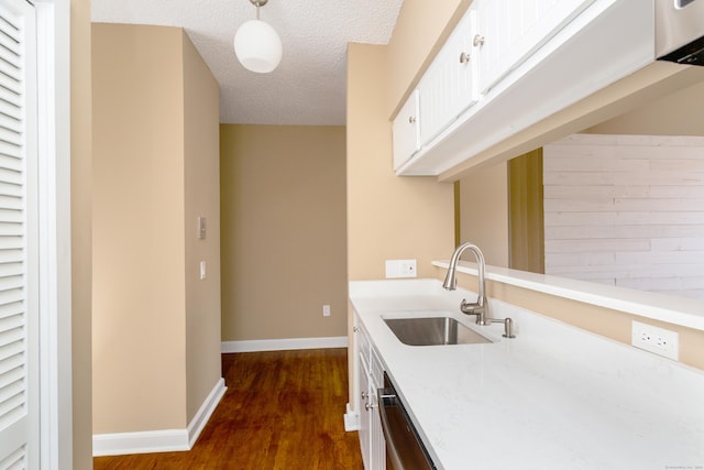 118 Washington St # U304, Norwalk, CT 06854 - kitchen with dark wood finished floors, white cabinetry, a textured ceiling, decorative light fixtures, and stainless steel dishwasher