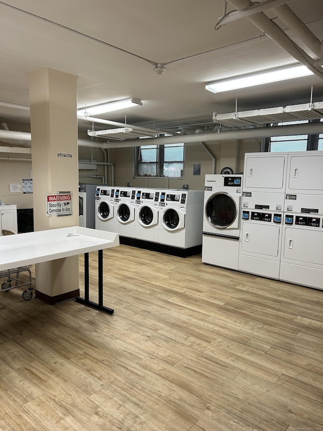 25 Cartright St Unit 1E, Bridgeport, CT 06604 - communal laundry room featuring stacked washer / dryer, light wood finished floors, a garage, and washer and dryer