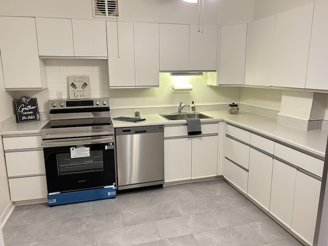 25 Cartright St Unit 1E, Bridgeport, CT 06604 - kitchen featuring stainless steel appliances, white cabinets, and light countertops
