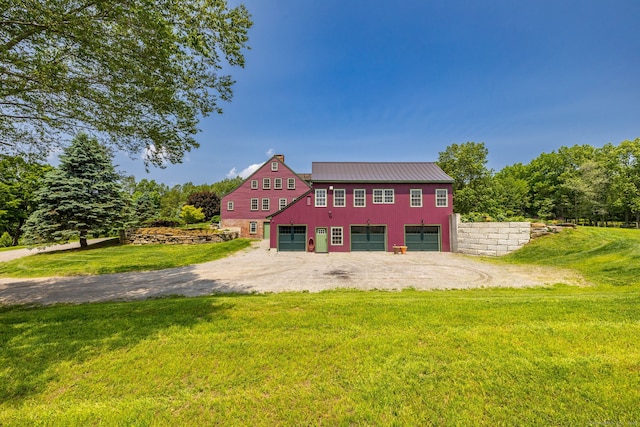 93 Northfield Rd, Litchfield, CT 06759 - view of front of home featuring a front lawn, dirt driveway, a metal roof, and a garage