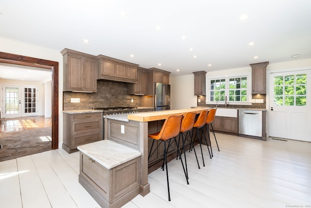 93 Northfield Rd, Litchfield, CT 06759 - kitchen featuring stainless steel appliances, decorative backsplash, a kitchen island, recessed lighting, and light wood-type flooring