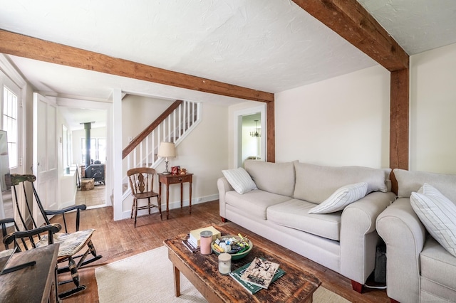 60 Pomperaug Rd, Woodbury, CT 06798 - living area with beamed ceiling, healthy amount of natural light, stairs, and wood finished floors