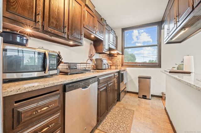 113E Country Squire Dr Unit 113E, Cromwell, CT 06416 - kitchen featuring appliances with stainless steel finishes, tasteful backsplash, light stone counters, and dark brown cabinetry