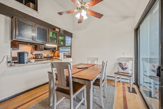 113E Country Squire Dr Unit 113E, Cromwell, CT 06416 - dining area featuring light wood-type flooring, ceiling fan, a towering ceiling, and a baseboard heating unit