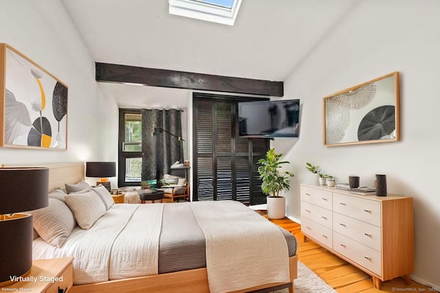 113E Country Squire Dr Unit 113E, Cromwell, CT 06416 - bedroom featuring a skylight, vaulted ceiling, and light wood-type flooring