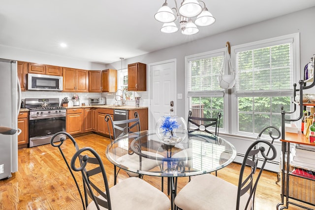 20 Oakland Ave Apt 3B, Danbury, CT 06810 - dining room featuring a baseboard heating unit, light wood-type flooring, and a chandelier