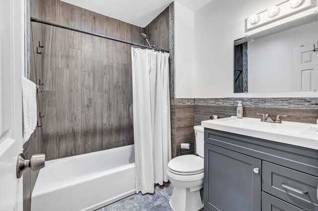 20 Oakland Ave Apt 3B, Danbury, CT 06810 - bathroom with vanity, shower / bathtub combination with curtain, tile walls, tile patterned flooring, and a wainscoted wall