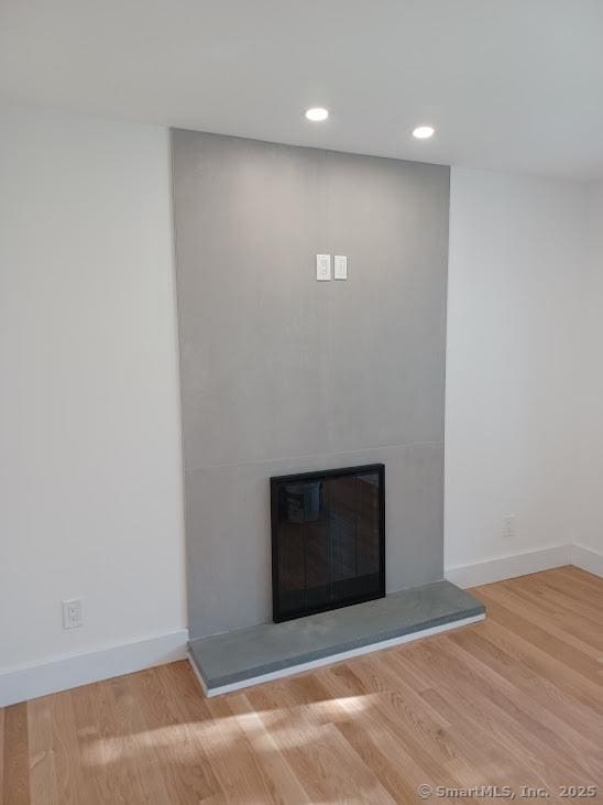 105 Houston Ter, Stamford, CT 06902 - detailed view of a fireplace, wood finished floors, and recessed lighting