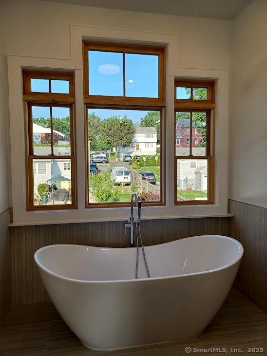 105 Houston Ter, Stamford, CT 06902 - full bath with wainscoting and a freestanding bath