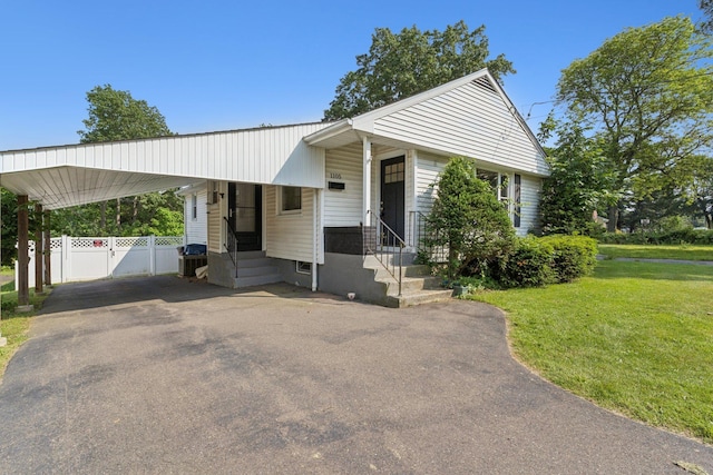 1105 Slater Rd, New Britain, CT 06053 - bungalow-style house with a carport, driveway, and entry steps