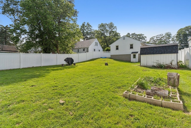 1105 Slater Rd, New Britain, CT 06053 - fenced backyard featuring a vegetable garden and a storage shed
