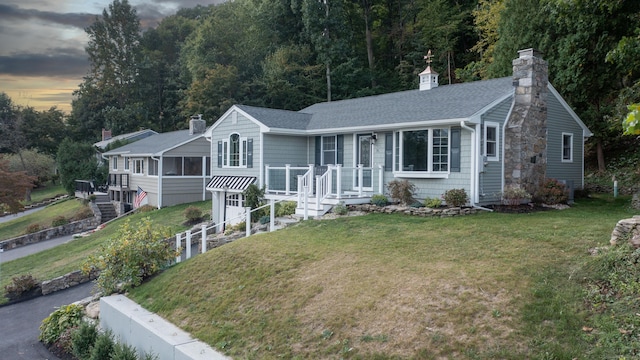 75 N Lake Shore Dr, Brookfield, CT 06804 - single story home with a chimney, stairs, a yard, a shingled roof, and a sunroom