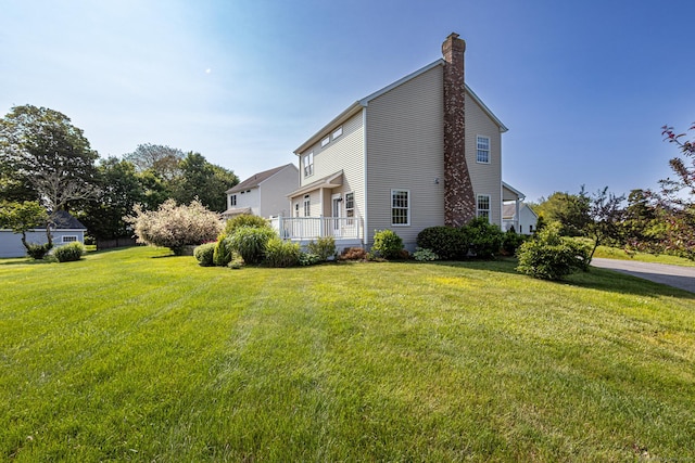 509 Main St Unit 6, Old Saybrook, CT 06475 - view of side of property featuring a chimney and a yard