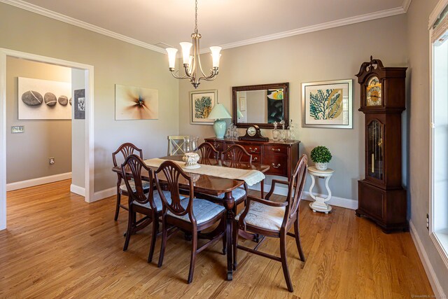 509 Main St Unit 6, Old Saybrook, CT 06475 - dining area featuring light wood-style flooring, a chandelier, and ornamental molding
