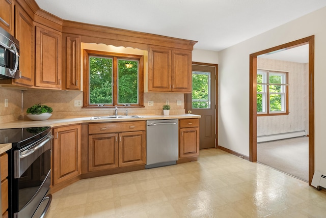 84 Bourbon St, South Windsor, CT 06074 - kitchen with stainless steel appliances, a baseboard radiator, light countertops, and brown cabinets