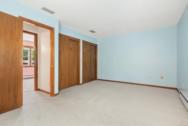 84 Bourbon St, South Windsor, CT 06074 - unfurnished bedroom featuring two closets, light colored carpet, and a baseboard radiator