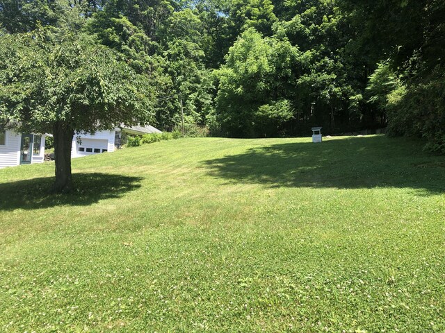 38 Upland Rd, Winchester, CT 06098 - view of green lawn with a garage