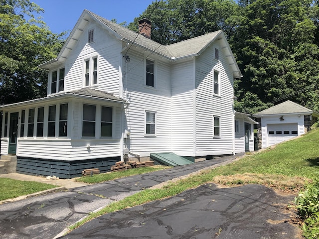 38 Upland Rd, Winchester, CT 06098 - view of side of home featuring entry steps, an outdoor structure, a chimney, and a shingled roof