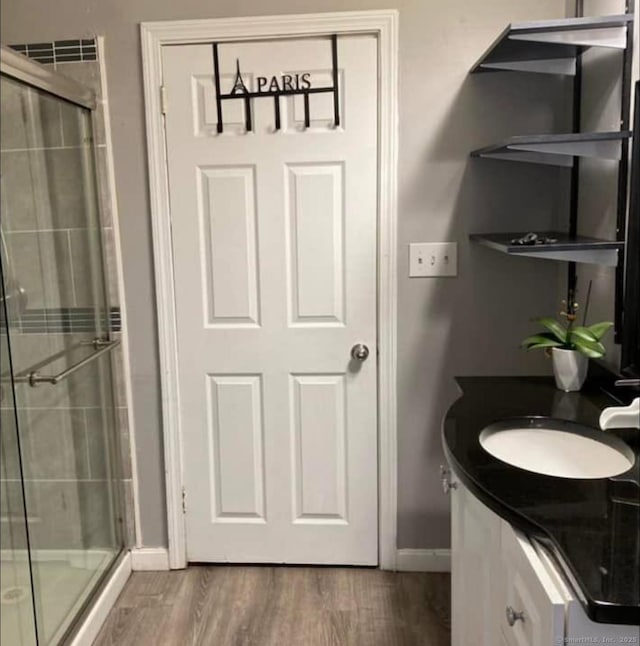 453 Burnside Ave, East Hartford, CT 06108 - bathroom featuring a stall shower, wood finished floors, and vanity