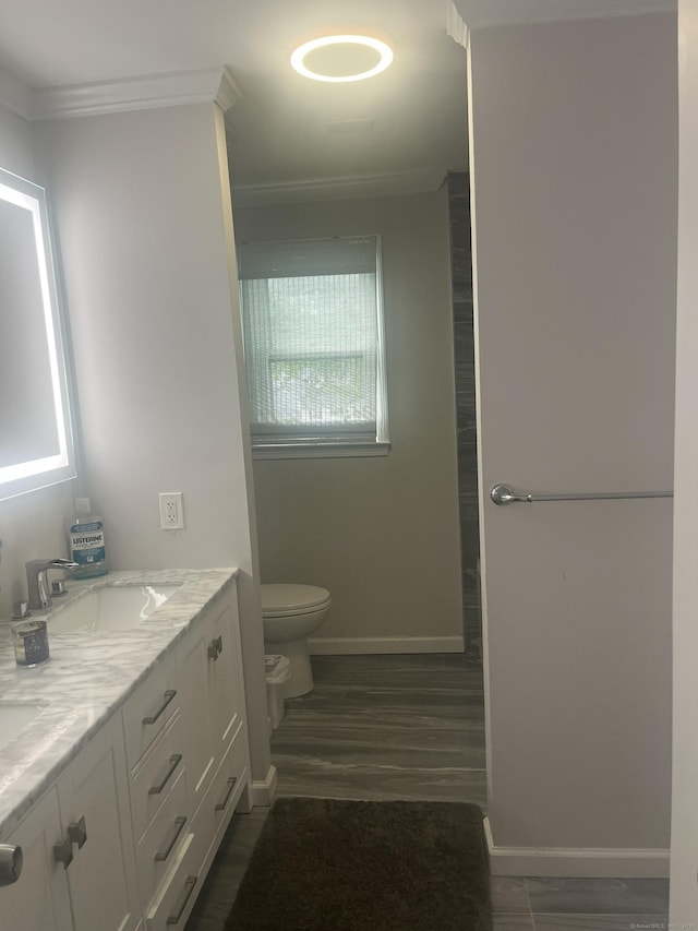 62 Haddad Rd, Waterbury, CT 06708 - bathroom with ornamental molding, double vanity, and wood finished floors