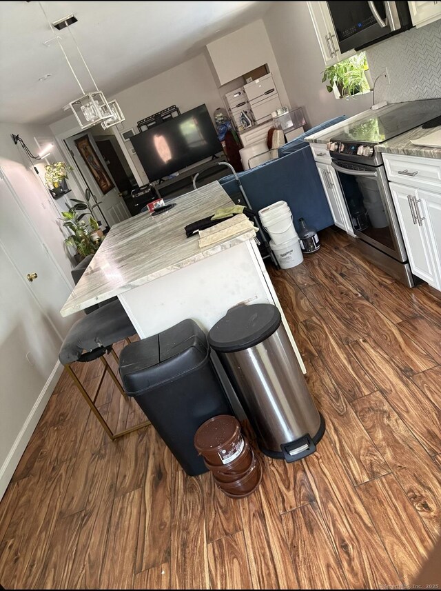 62 Haddad Rd, Waterbury, CT 06708 - kitchen with stainless steel appliances, dark wood-style floors, white cabinetry, light countertops, and tasteful backsplash