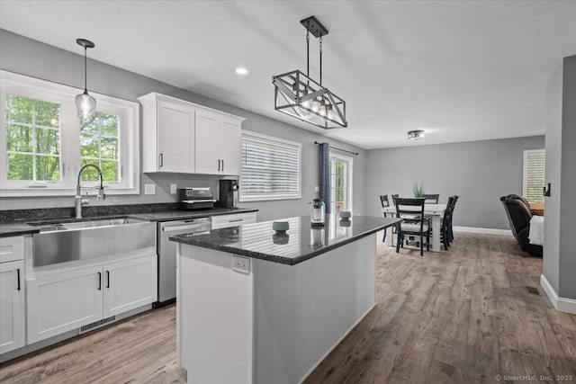 379 Tripp Hollow Rd, Brooklyn, CT 06234 - kitchen featuring stainless steel dishwasher, white cabinetry, healthy amount of natural light, wood finished floors, and recessed lighting