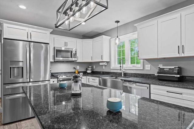 379 Tripp Hollow Rd, Brooklyn, CT 06234 - kitchen with appliances with stainless steel finishes, white cabinetry, dark stone countertops, hanging light fixtures, and recessed lighting