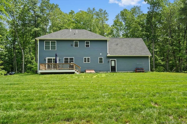 379 Tripp Hollow Rd, Brooklyn, CT 06234 - rear view of house featuring a wooden deck, a yard, roof with shingles, and view of wooded area