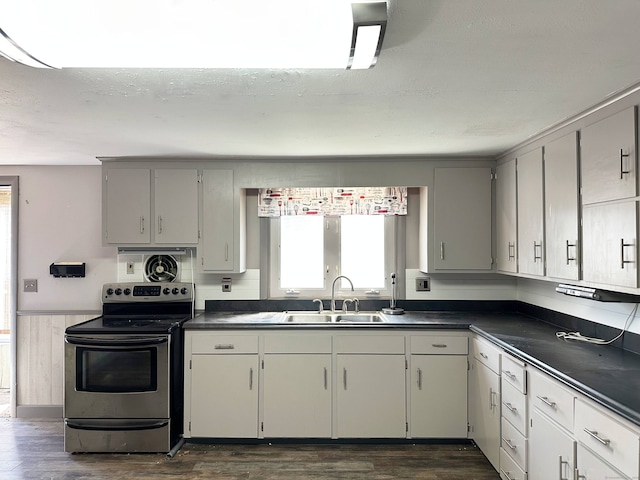 70 Cedar Ridge Rd, Newington, CT 06111 - kitchen featuring stainless steel range with electric stovetop, dark countertops, dark wood finished floors, and a wainscoted wall