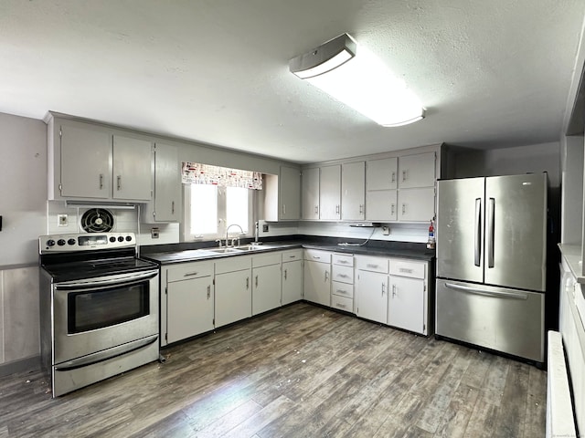 70 Cedar Ridge Rd, Newington, CT 06111 - kitchen with stainless steel appliances, dark countertops, dark wood-type flooring, gray cabinets, and a textured ceiling