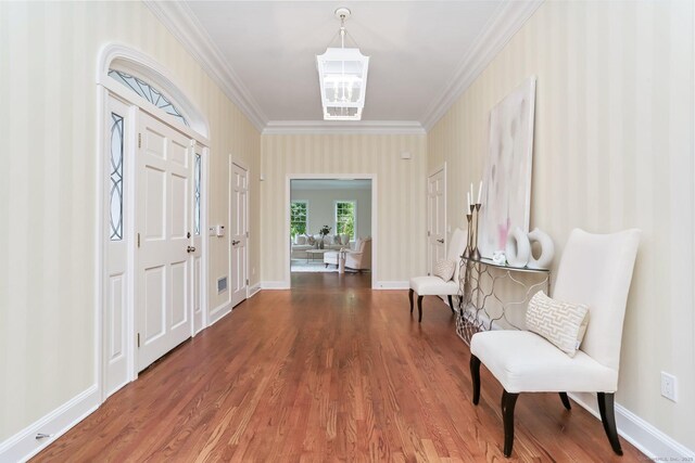 2787 Redding Rd, Fairfield, CT 06824 - entryway featuring crown molding, wood finished floors, and wallpapered walls