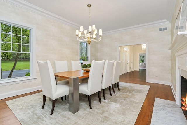 2787 Redding Rd, Fairfield, CT 06824 - dining area featuring a chandelier, ornamental molding, plenty of natural light, a high end fireplace, and wood finished floors