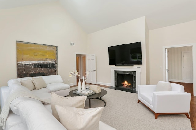 2787 Redding Rd, Fairfield, CT 06824 - living area featuring a high end fireplace, high vaulted ceiling, and wood finished floors